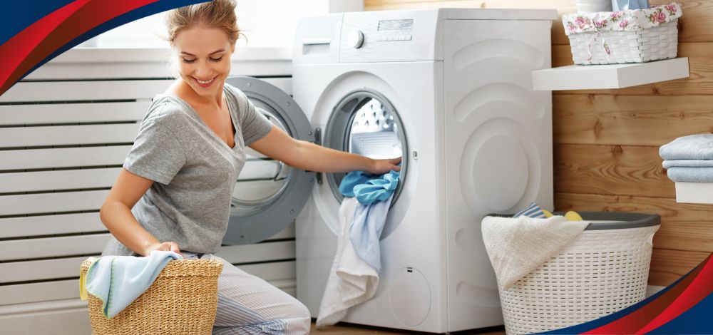 A woman doing laundry with a low-priced Midea automatic washing machine