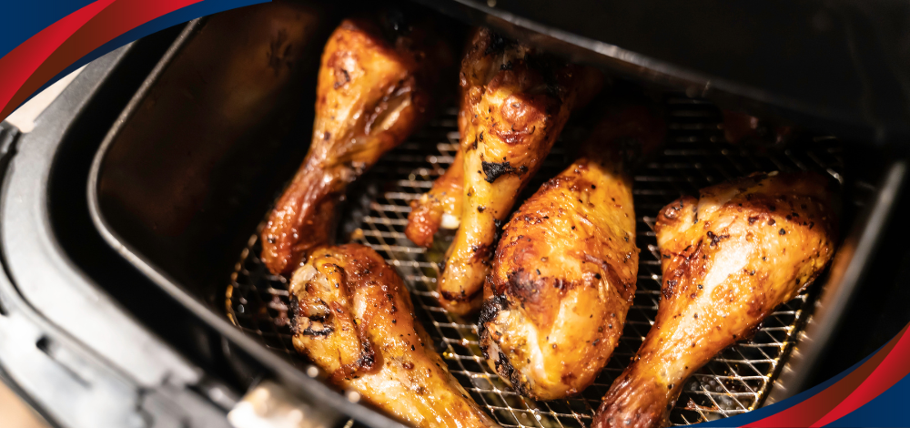 Cooked chicken drumsticks inside an air fryer, illustrating Hanabishi air fryers in the Philippines