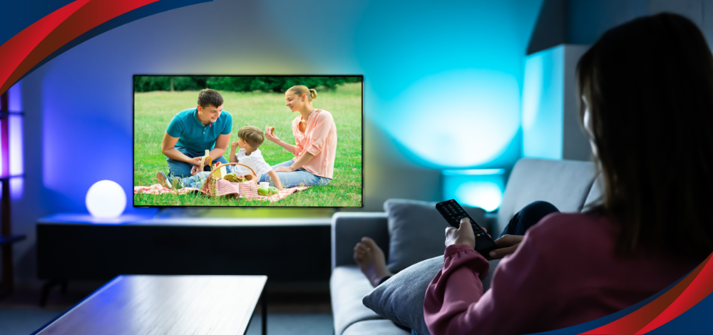 Photo of a woman watching a movie from an LED TV in the Philippines