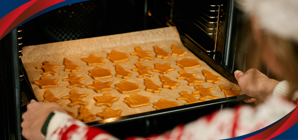 Photo of a person baking Christmas treats with an electric oven
