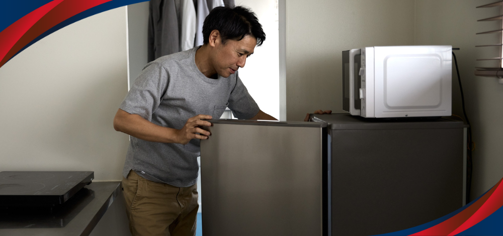 A photo of a person opening an energy saving single door refrigerator